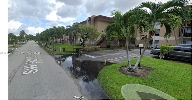 view of home's community with a lawn