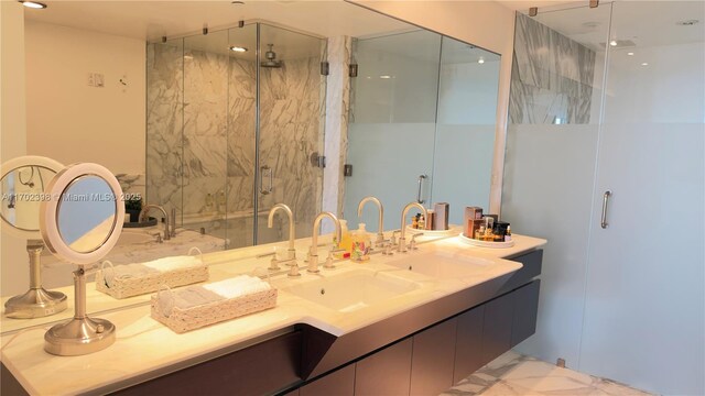 bathroom with walk in shower and vanity