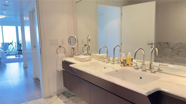 bathroom with a tub to relax in and vanity