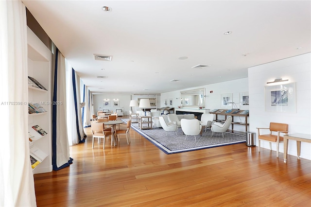 living room with hardwood / wood-style floors and built in features