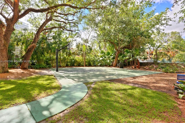 view of home's community with a lawn and basketball hoop