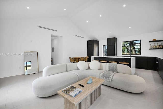 living room with high vaulted ceiling