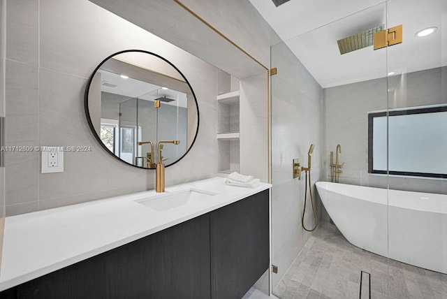 bathroom with vanity, independent shower and bath, and tile walls