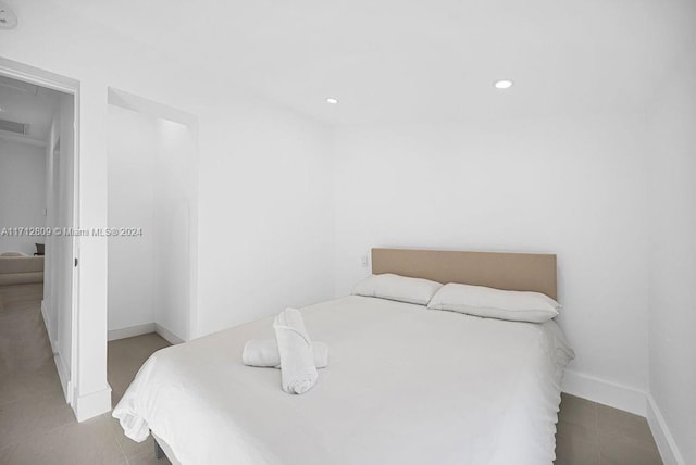 bedroom with light tile patterned floors