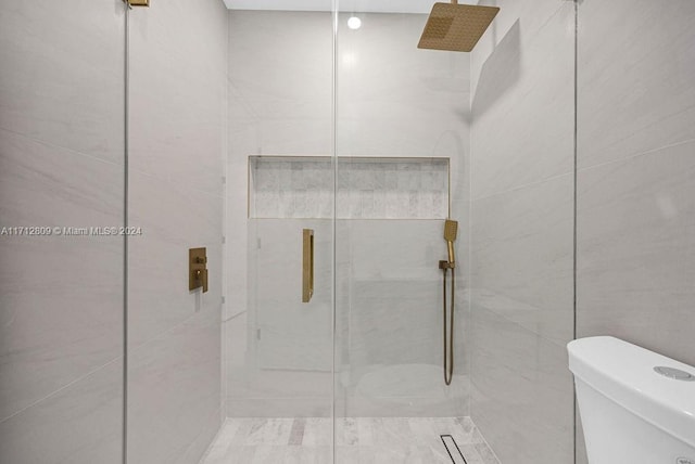 bathroom with toilet and walk in shower