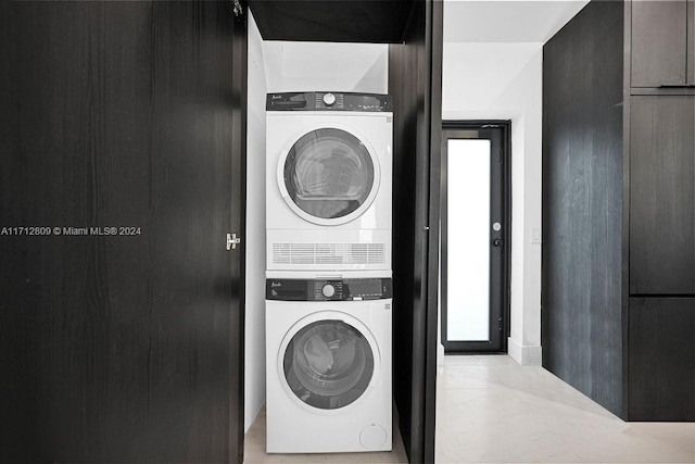 washroom featuring stacked washer / dryer