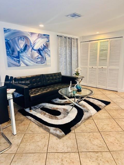 living room with tile patterned flooring