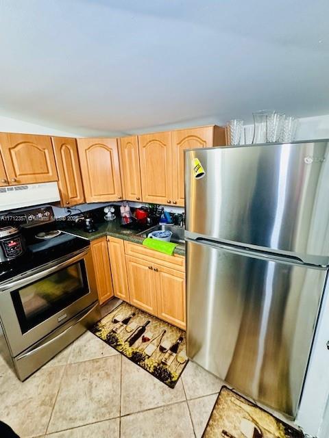 kitchen with light tile patterned flooring and appliances with stainless steel finishes