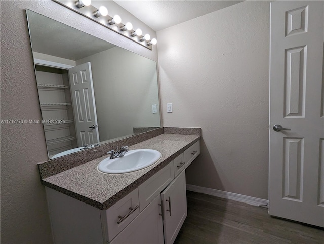 bathroom featuring vanity and hardwood / wood-style flooring