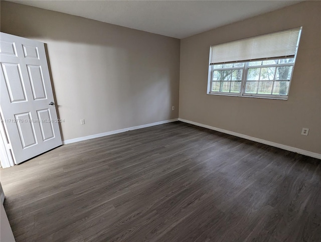 empty room featuring dark wood-type flooring