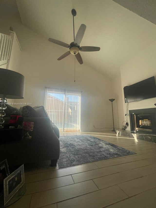 bedroom featuring hardwood / wood-style flooring, ceiling fan, and high vaulted ceiling