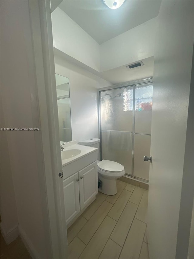 bathroom with vanity, toilet, and walk in shower