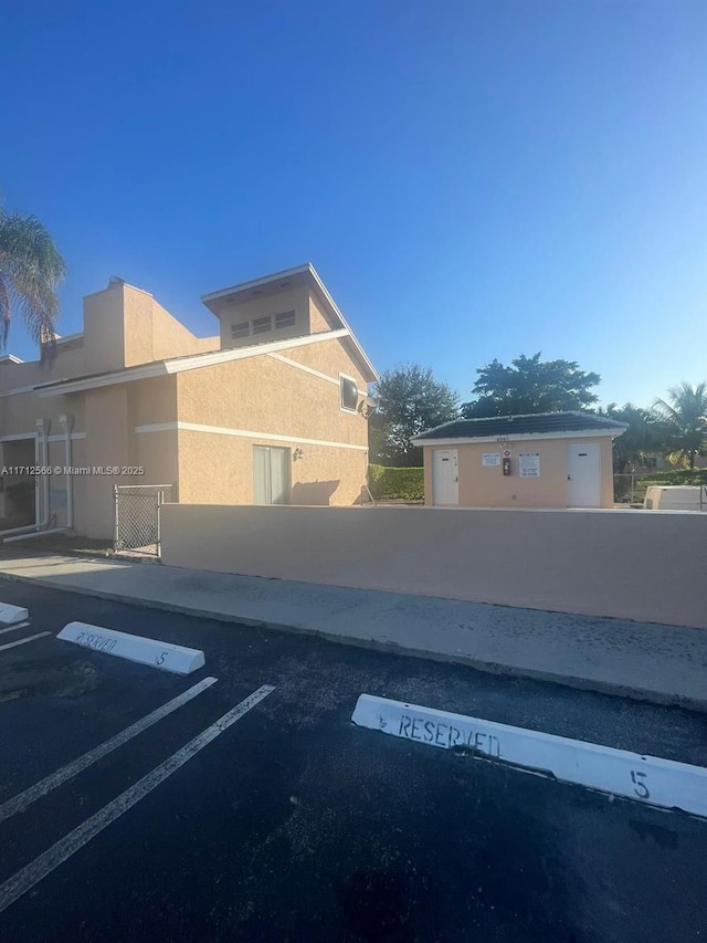 4075 Coral Springs Dr Unit 5, Coral Springs, FL 33065 - uncovered parking lot featuring fence private yard