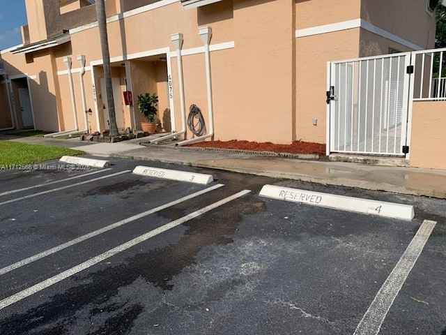 4075 Coral Springs Dr Unit 5, Coral Springs, FL 33065 - uncovered parking lot with a gate