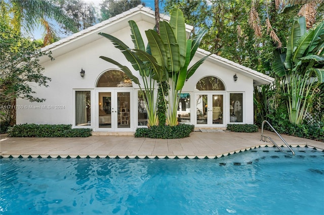 back of property with french doors and a patio