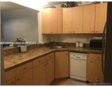 kitchen with dishwasher, light brown cabinets, and sink