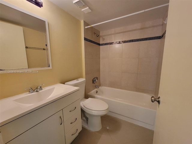 full bathroom with tile patterned flooring, vanity, toilet, and tiled shower / bath