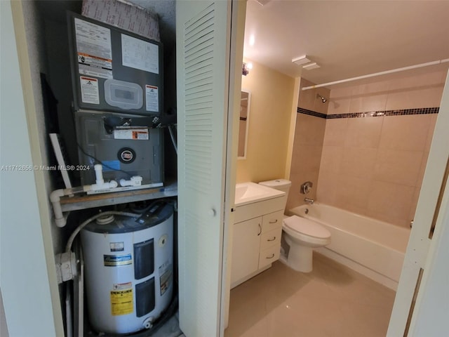 full bathroom with tile patterned floors, vanity, tiled shower / bath combo, water heater, and toilet