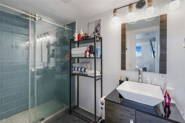 bathroom with a shower with door and vanity