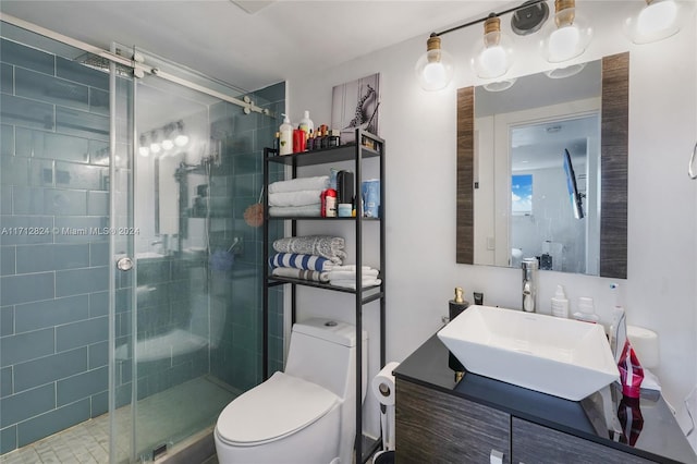 bathroom with vanity, an enclosed shower, and toilet