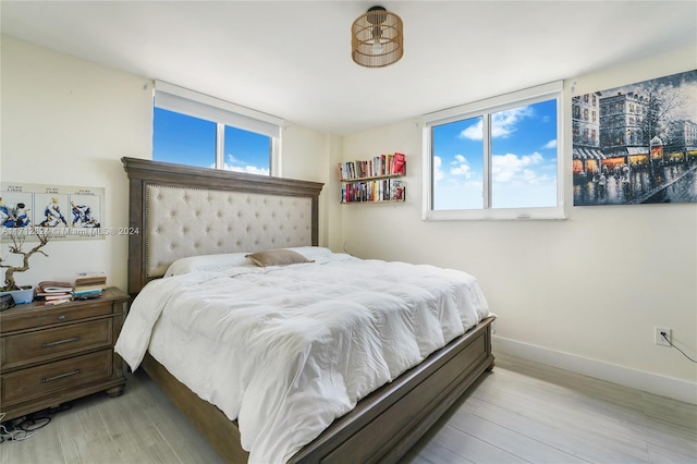 bedroom featuring light hardwood / wood-style floors and multiple windows