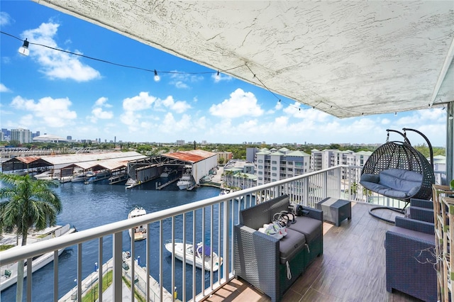 balcony featuring an outdoor living space and a water view