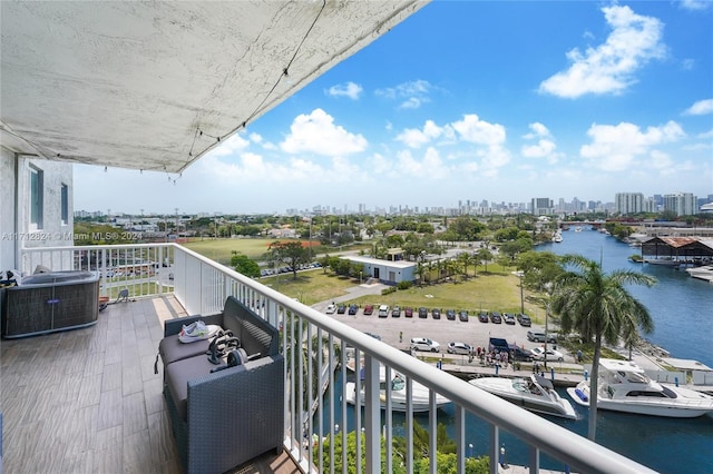 balcony featuring a water view and cooling unit