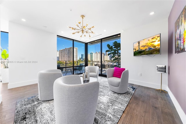 living room with dark hardwood / wood-style floors, an inviting chandelier, and expansive windows