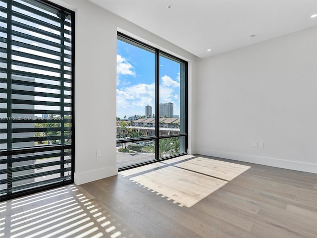 spare room with hardwood / wood-style flooring