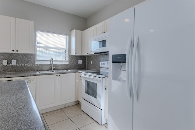 kitchen with white appliances, tasteful backsplash, white cabinetry, and sink