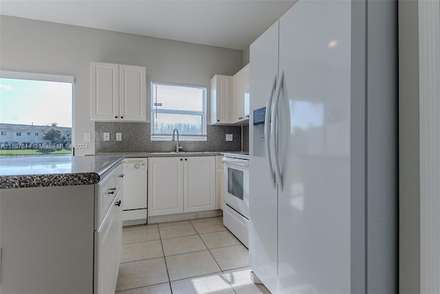 kitchen with white cabinets, sink, white appliances, and backsplash