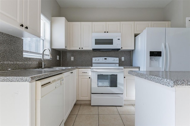 kitchen with white cabinetry, sink, white appliances, decorative backsplash, and light tile patterned flooring