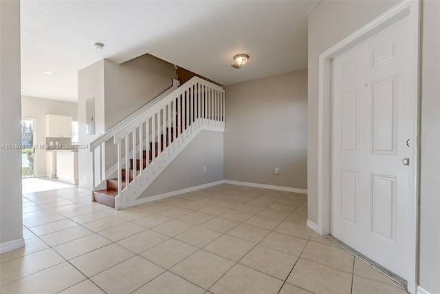 staircase with tile patterned floors