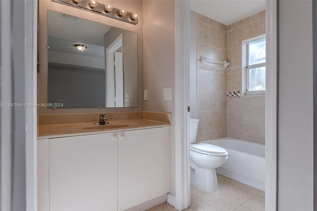 full bathroom featuring tile patterned flooring, vanity, toilet, and tiled shower / bath