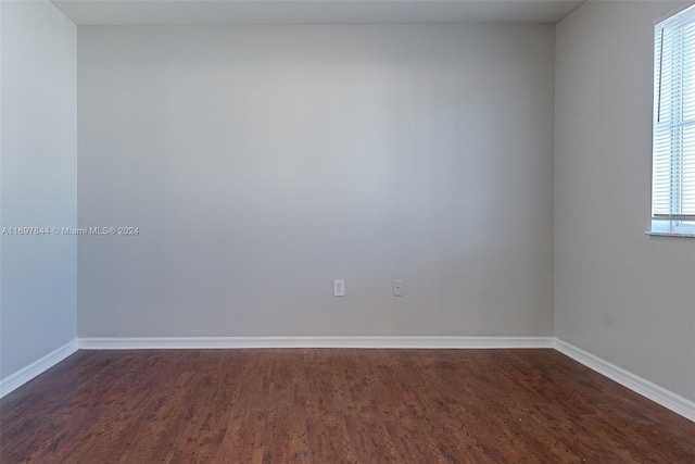 empty room with dark hardwood / wood-style floors