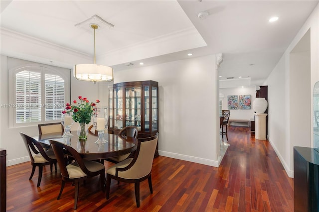 dining space with crown molding and dark hardwood / wood-style flooring