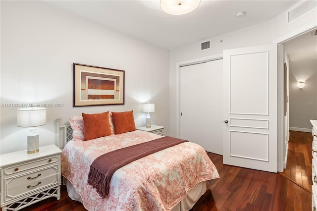 bedroom featuring a closet and dark wood-type flooring