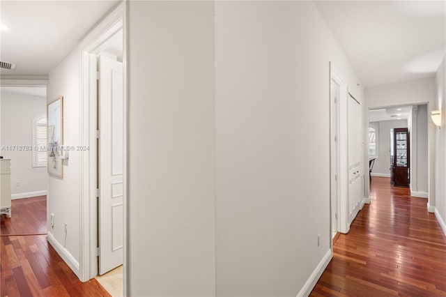 corridor with hardwood / wood-style floors