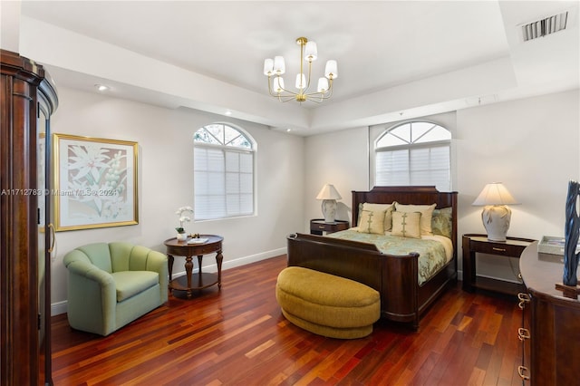 bedroom featuring a chandelier and dark hardwood / wood-style floors