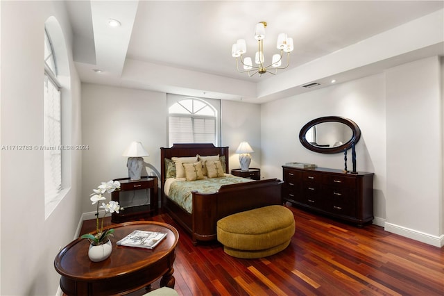 bedroom featuring dark hardwood / wood-style floors and a chandelier