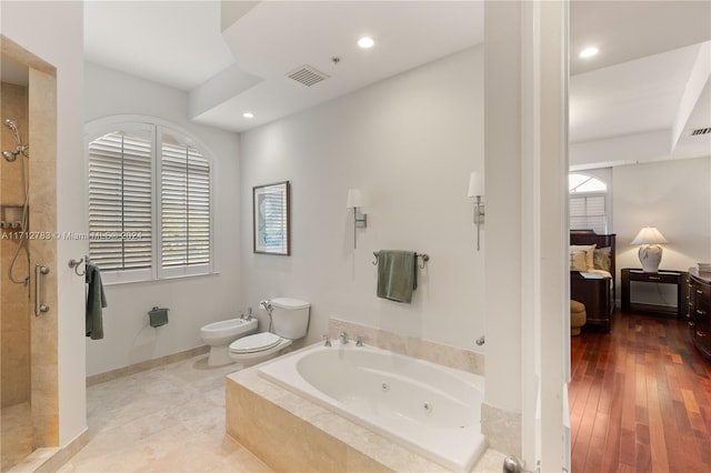 bathroom featuring hardwood / wood-style flooring, toilet, a bidet, and independent shower and bath