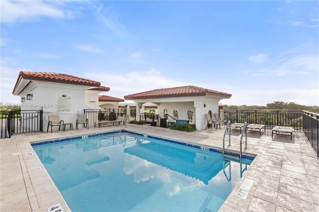 view of pool featuring an outdoor structure and a patio