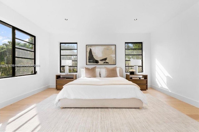 bedroom featuring light hardwood / wood-style flooring and multiple windows