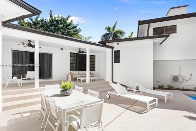 view of patio with an outdoor living space and ceiling fan