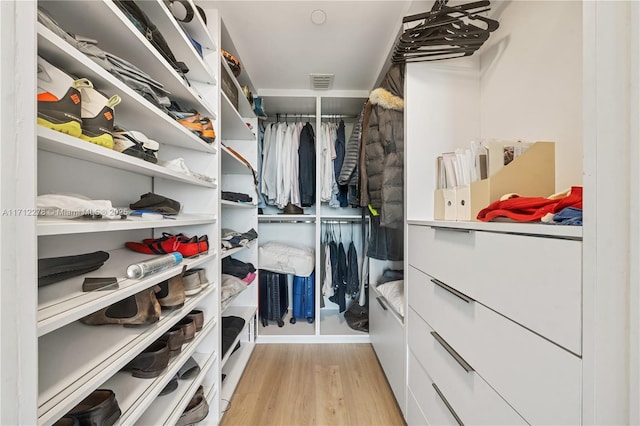 spacious closet with light hardwood / wood-style floors