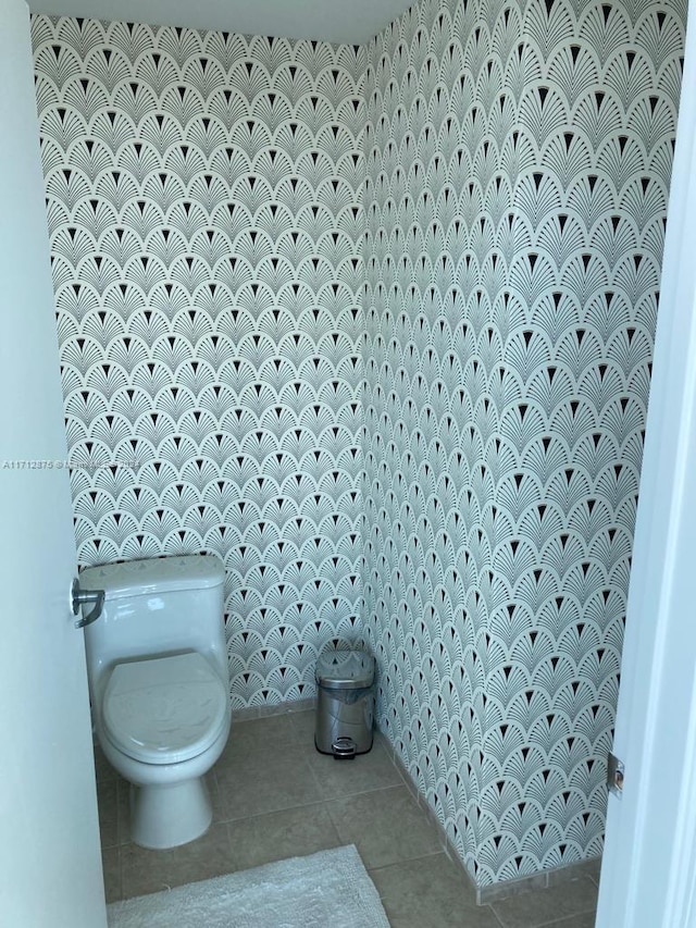 bathroom with toilet and tile patterned floors