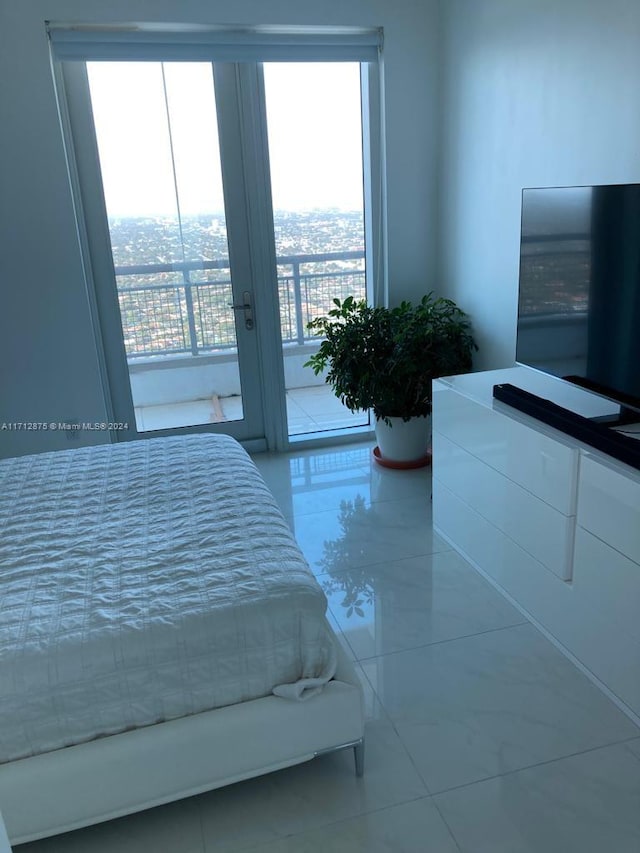 bedroom featuring access to exterior and tile patterned floors