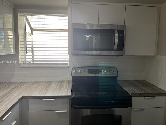 kitchen featuring backsplash and stainless steel appliances