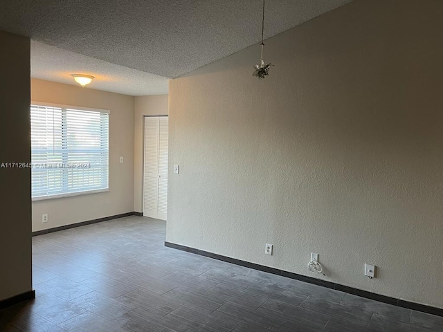 unfurnished room featuring a textured ceiling