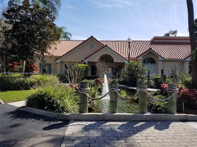 mediterranean / spanish house with a water view